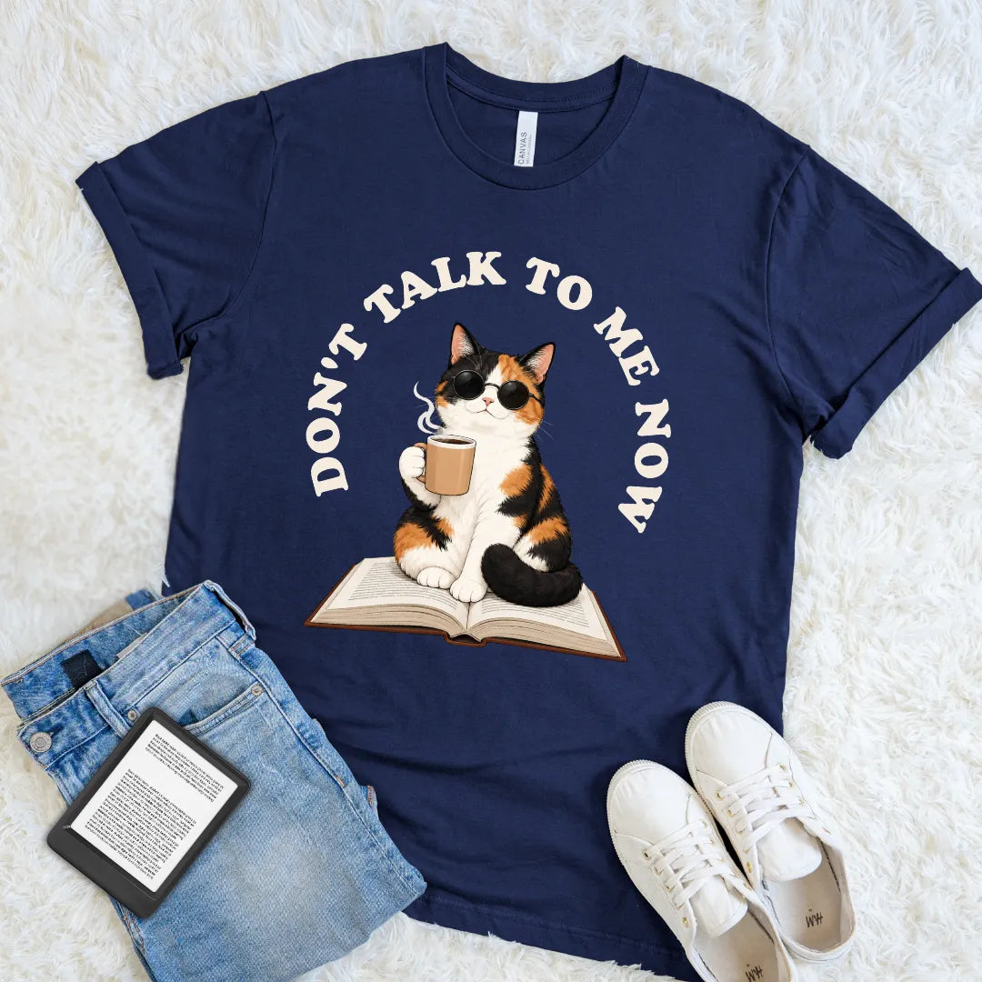 Navy bookish graphic shirt with a cool calico cat reading over an open book, made for introverts and cat lovers