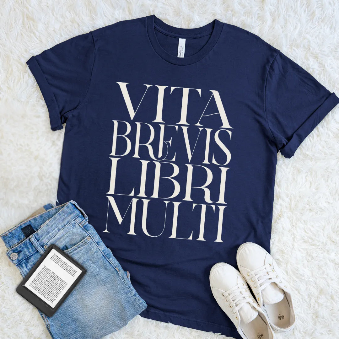 Navy bookish T-shirt featuring the Latin phrase Vita Brevis Libri Multi in oversized cream typography.