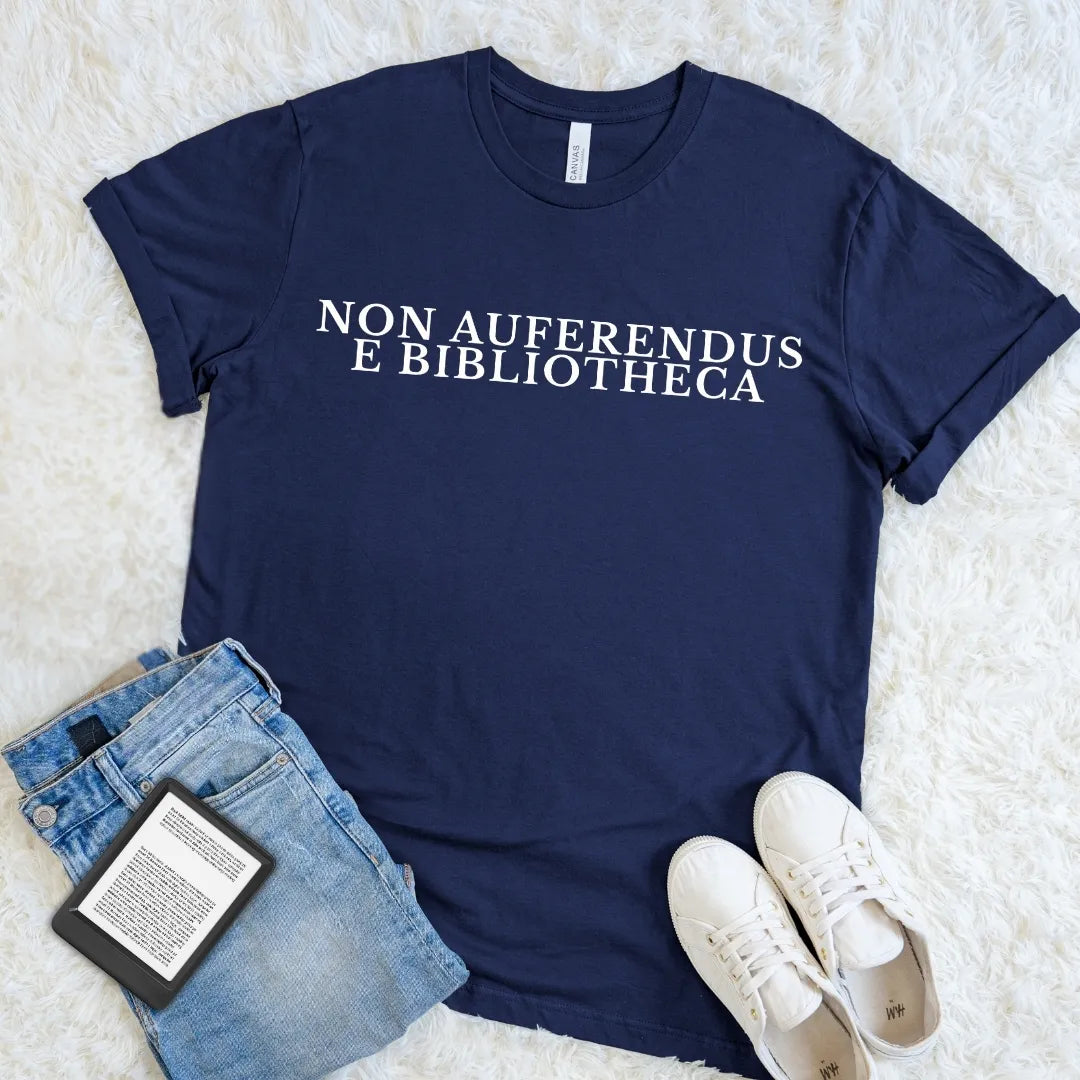 Navy Non Auferendus E Bibliotheca library T-shirt featuring a cream Latin quote meaning “do not remove from the library,” a dark academia bookish graphic tee for readers, librarians, book lovers, and classic literature fans.