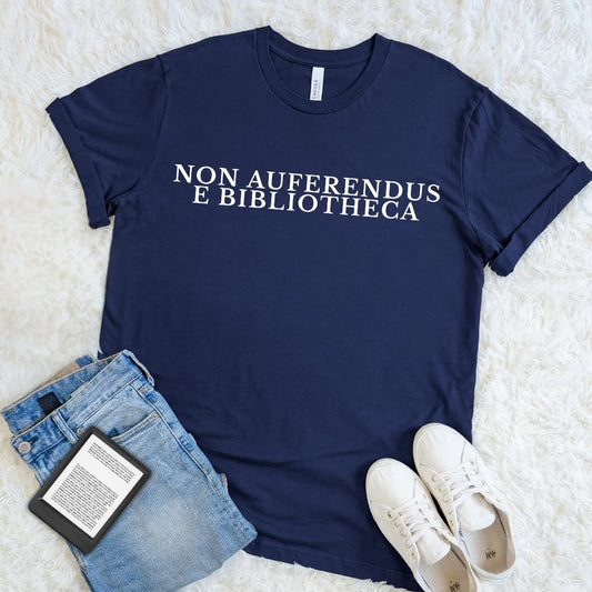 Navy Non Auferendus E Bibliotheca library T-shirt featuring a cream Latin quote meaning “do not remove from the library,” a dark academia bookish graphic tee for readers, librarians, book lovers, and classic literature fans.