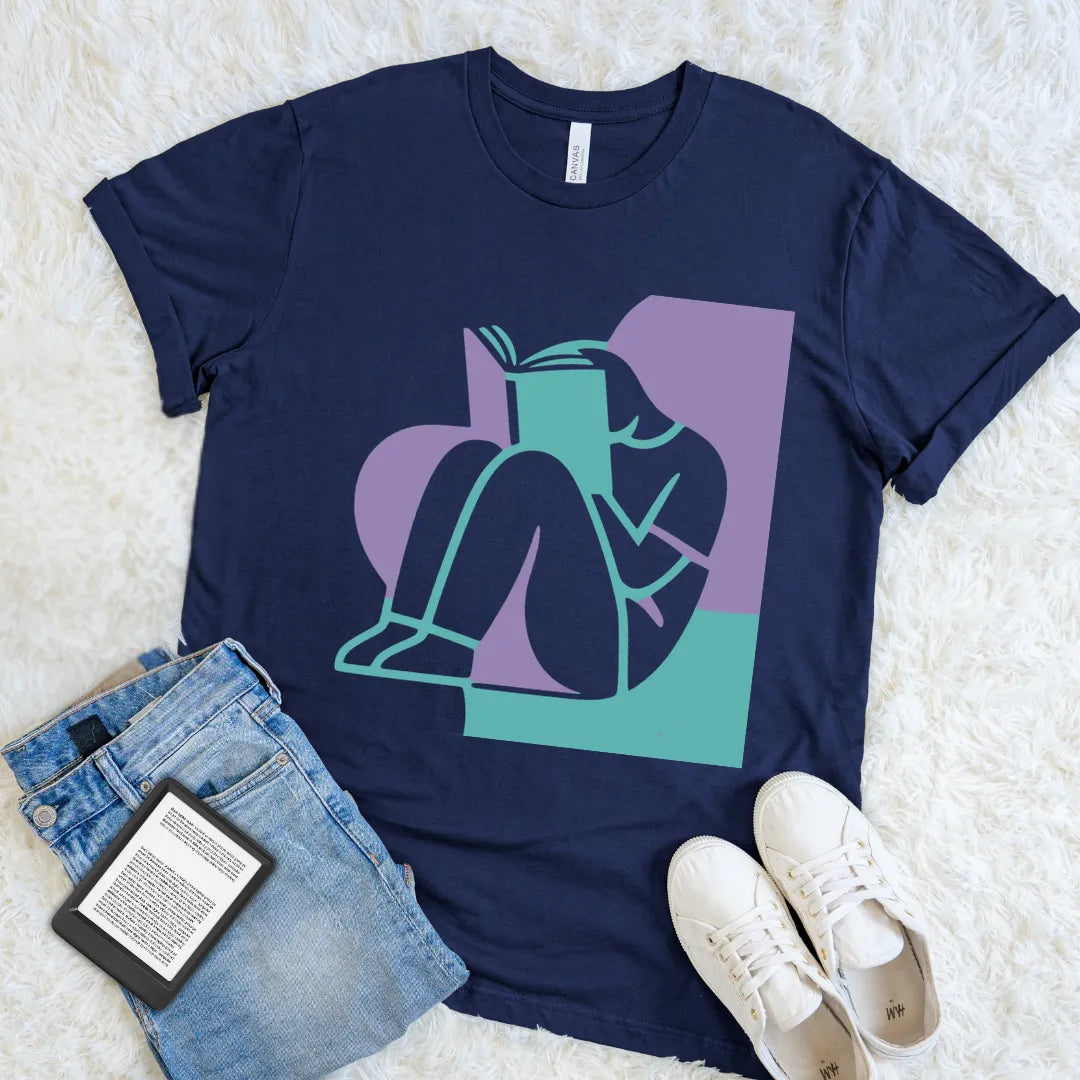 Navy Lost In A Book T-shirt with a teal and lavender abstract reader illustration, a colorful minimalist graphic tee for book lovers.