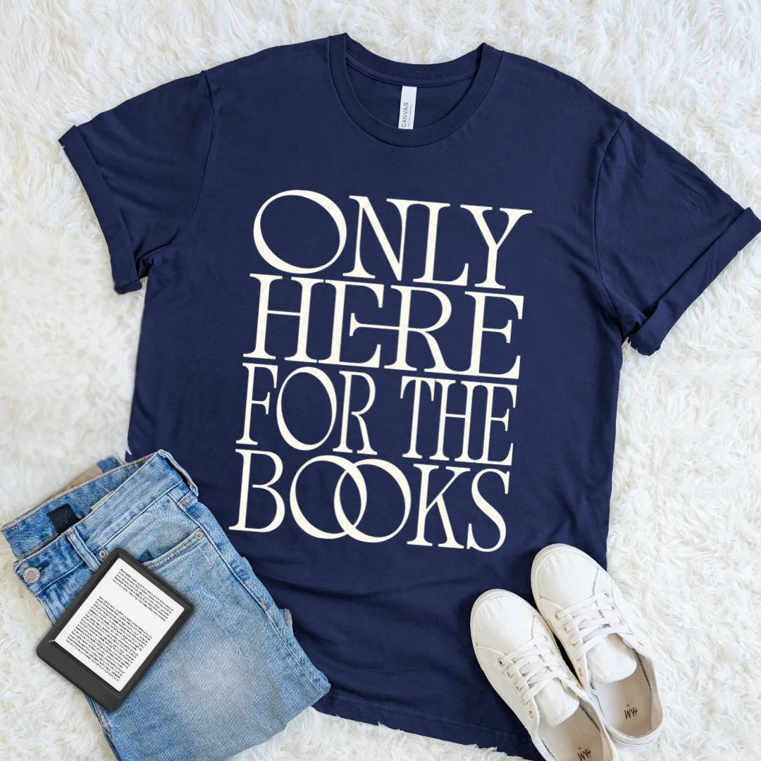 Navy Only Here for the Books T-shirt with oversized cream vintage typography, styled with jeans, white sneakers, and an e-reader