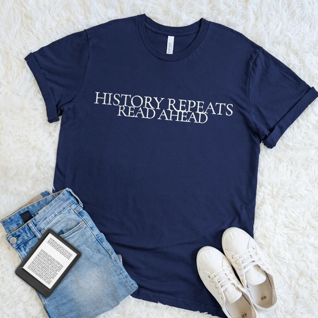 Navy blue  typography t-shirt for book livers featuring the phrase “History Repeats, Read Ahead” in vintage-inspired lettering. A minimalist literary graphic tee for readers, history lovers, teachers, and fans of academia style.