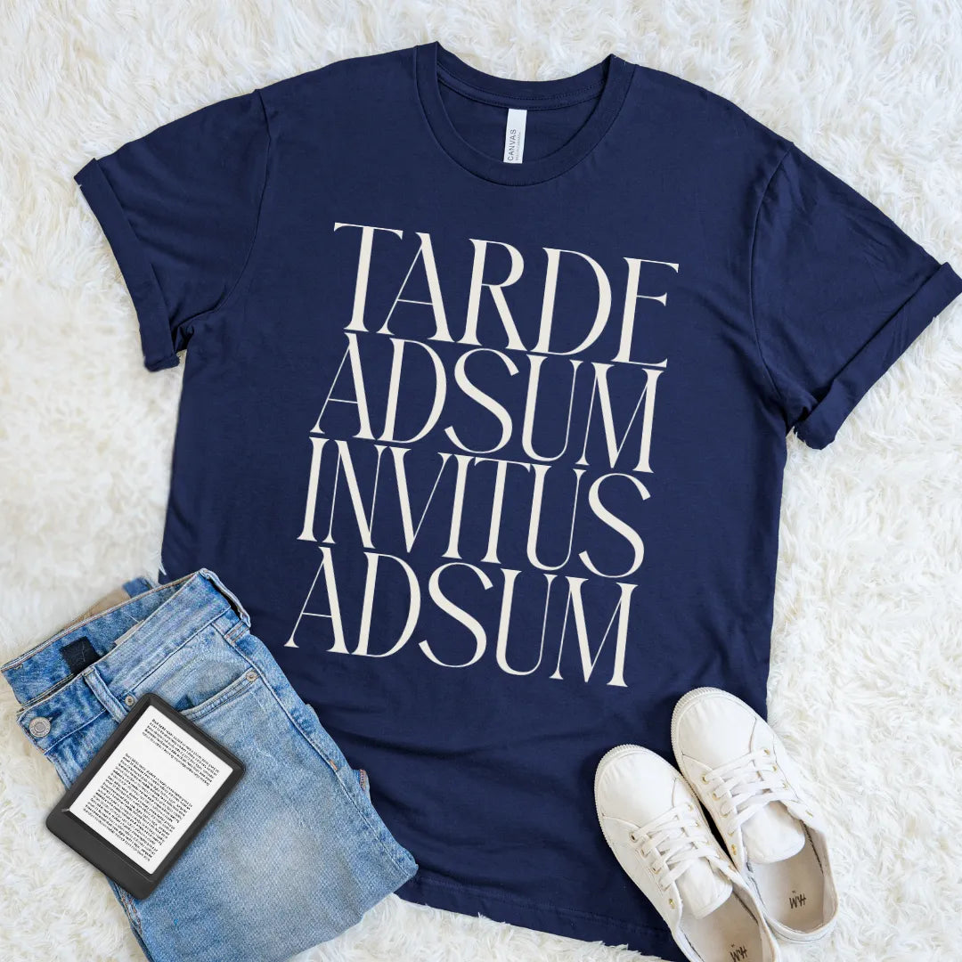 Navy Tarde Adsum Invitus Adsum T-shirt with bold cream Latin typography, a literary dark academia shirt for reluctant attendees, readers, and Latin students.