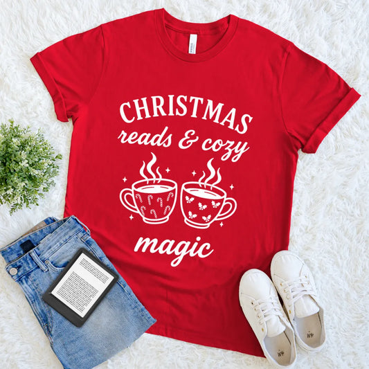 Holiday book lover tee featuring two steaming cups with holly and candy cane white patterns on red