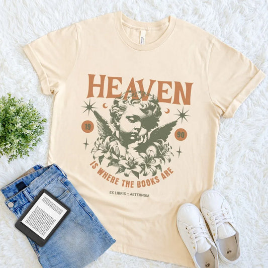 Soft Cream cotton bookish T-shirt with vintage angel graphic and “Heaven Is Where the Books Are” text