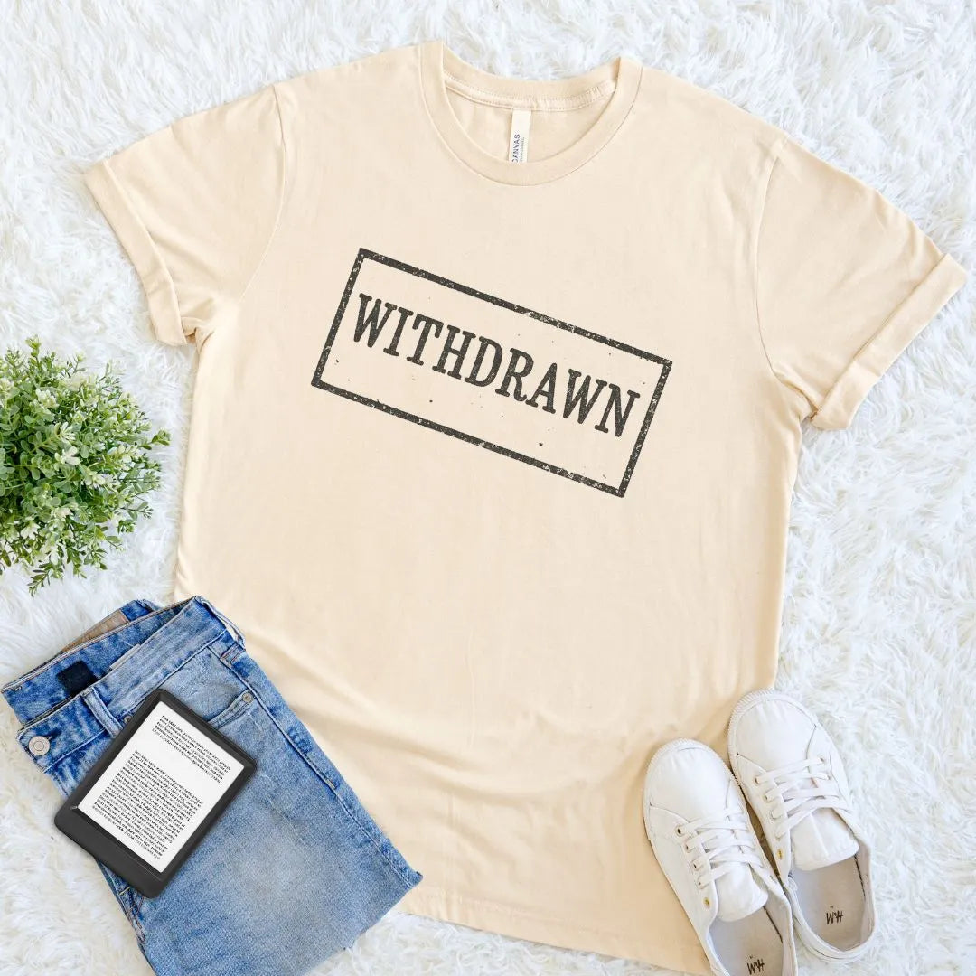 Cotton soft cream bookish T-shirt with bold “Withdrawn” library stamp design in black