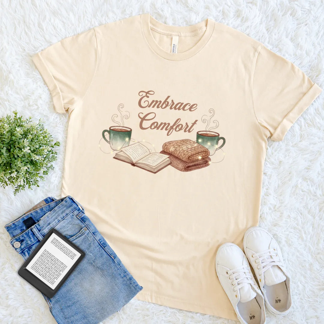 Soft cream cream cotton T-shirt with “Embrace Comfort” text and cozy graphic