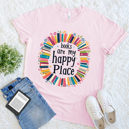 Flat lay of book lover graphic tee in soft pink vintage tones and “Books Are My Happy Place” text