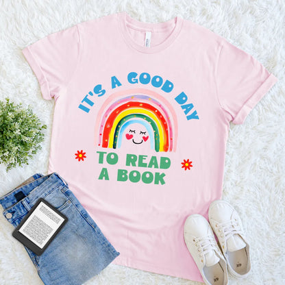 Pink bookish tee with motivational quote and vibrant rainbow design 