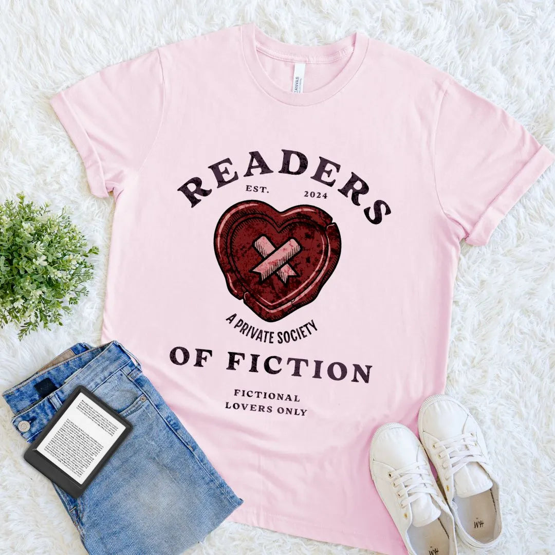Soft pink book lover T-shirt with distressed red heart and vintage badge style 