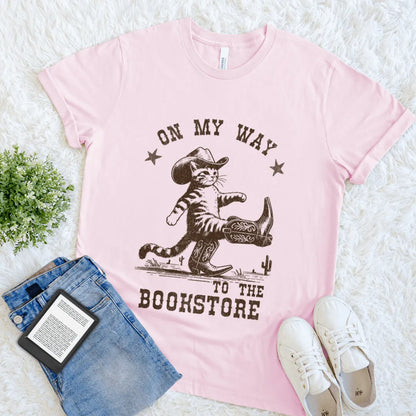 Cozy reader shirt with playful typography and Wild West feline vibe in soft pink