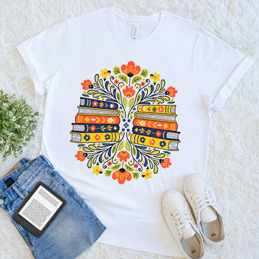 Colorful floral pattern framing books on a white reader tee