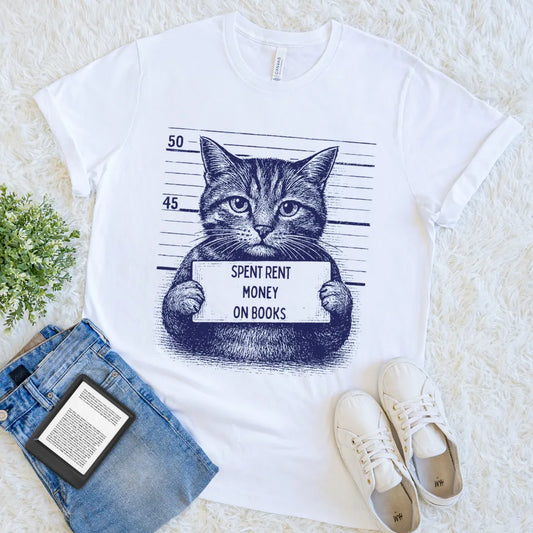 White tee with cat mugshot holding a “Spent Rent Money on Books” sign