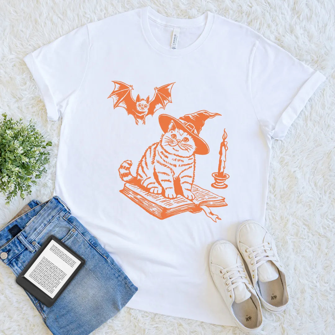 witchy reading shirt featuring cat on spell book