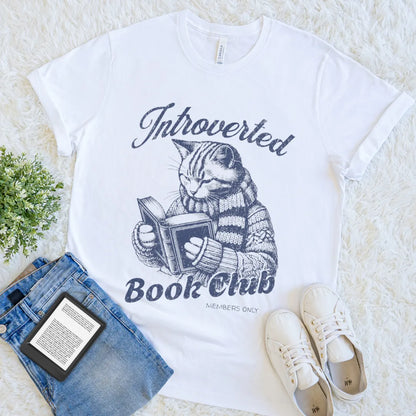 “Introverted Book Club” white t-shirt with cozy sweater cat reading book
