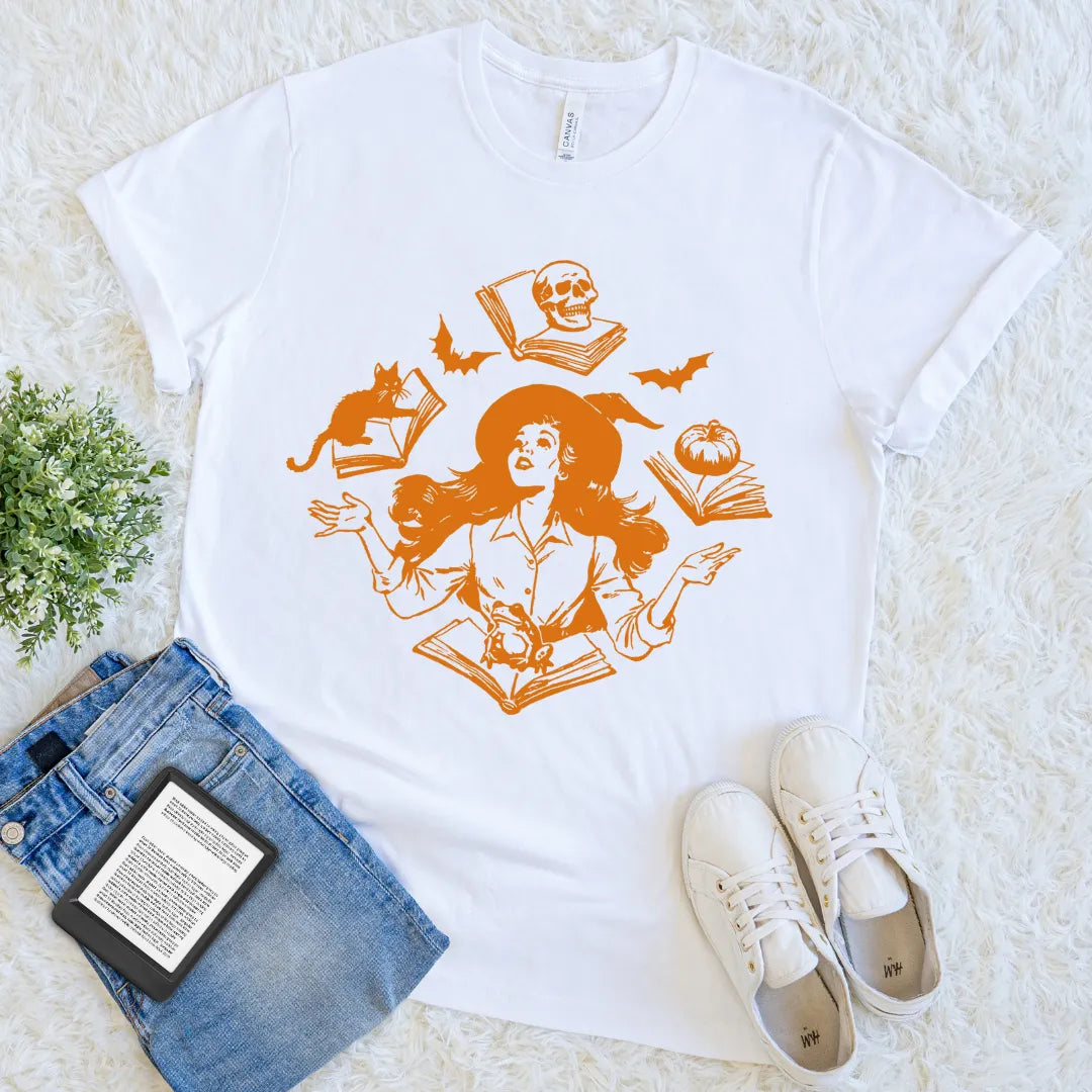 witch juggling books with bats and skulls vintage halloween  tee
