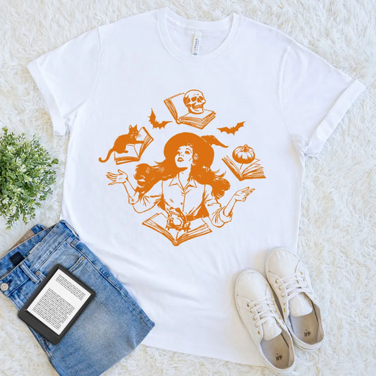 witch juggling books with bats and skulls vintage halloween  tee