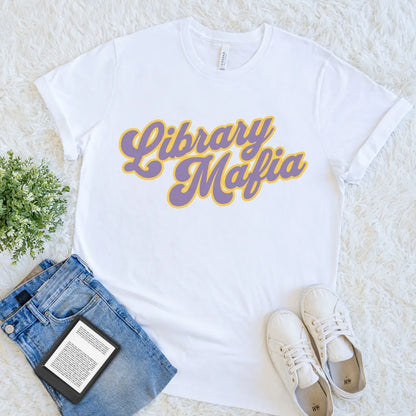 White librarian T-shirt with purple-and-gold Library Mafia typography for book club members and devoted readers