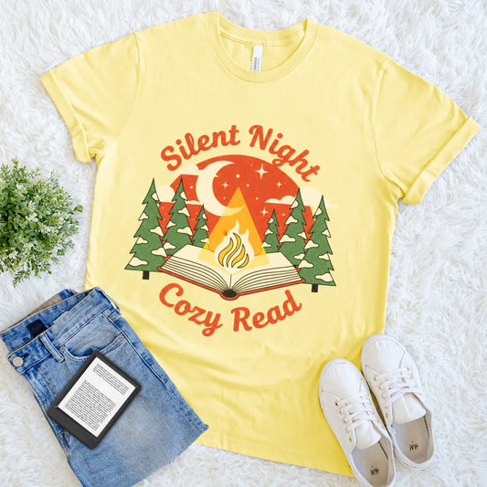 “Silent Night Cozy Read” text above peaceful bookish forest scene on yellow t-shirt