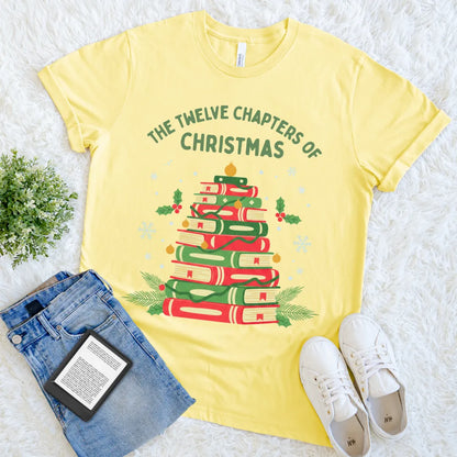yellow graphic T-shirt with book stack shaped like a Christmas tree and festive decorations