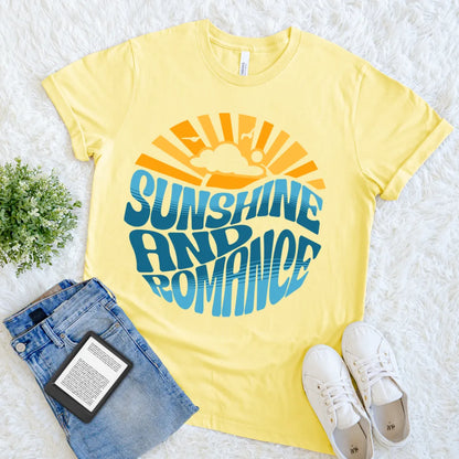 Yellow soft cotton tee featuring orange sunburst and blue wavy bookish lettering