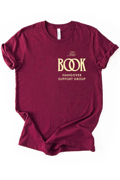 Soft cotton maroon red minimalist graphic t-shirt with gold logo  reading “The Book Hangover Support Group”