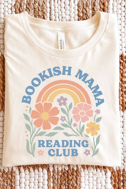 soft cotton natural beige graphic t-shirt with pastel floral illustrations, a rainbow, and the text “Bookish Mama Reading Club” in a cozy bookish style, folded on textile surface
