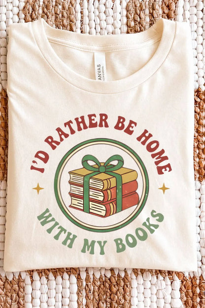Soft cotton natural beige  retro graphic t-shirt featuring a stack of books tied with a green ribbon and the phrase “I’d Rather Be Home With My Books” in vintage red and green lettering.