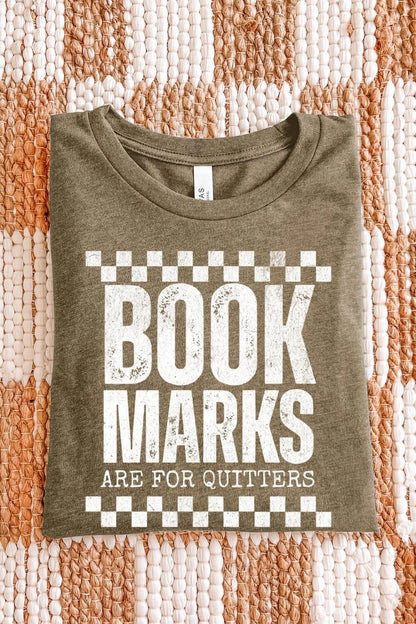 heather olive T-shirt with bold white distressed text “Bookmarks Are for Quitters” and checkered design