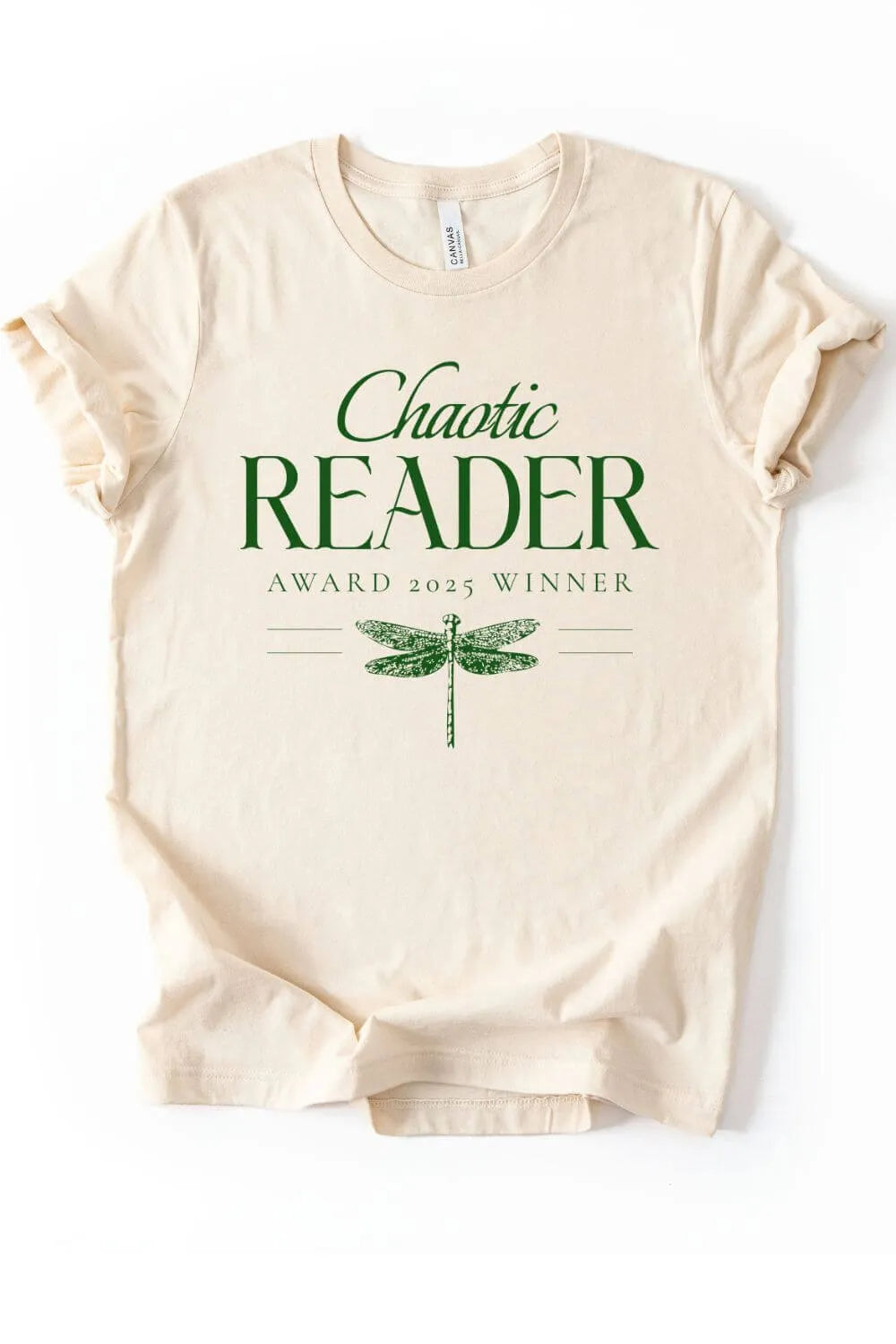 Flat lay of soft cotton cream t-shirt with vintage dragonfly illustration and "Chaotic reader award 2025 winner" text in elegant dark green typography 