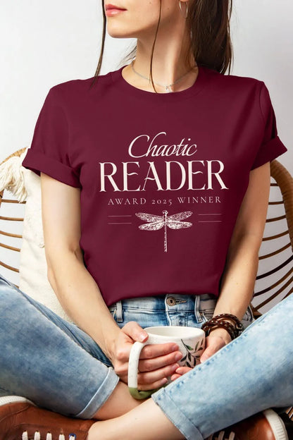 Woman wearing  soft cotton maroon t-shirt with “Chaotic Reader Award 2025 Winner” text and vintage dragonfly illustration