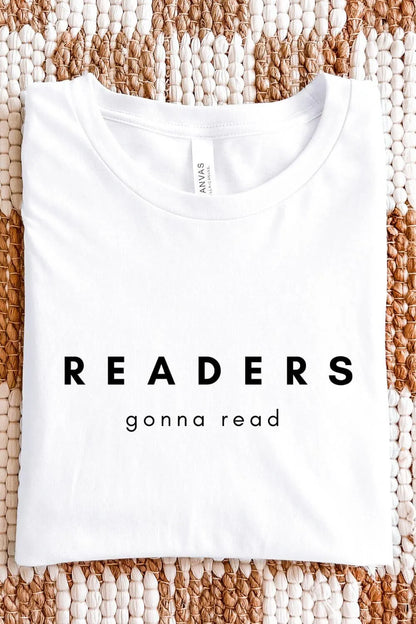 A white minimalist t-shirt with bold black text reading “Readers Gonna Read,” designed in a clean bookish aesthetic, folded on textile background