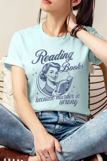woman wearing heather Ice blue  t-shirt with vintage design and “Reading Books Because Murder is Wrong” text styled with  denim 