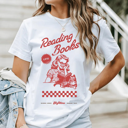 woman wearing white vintage soft cotton bookish tee for night readers with retro design featuring woman reading book and a cat