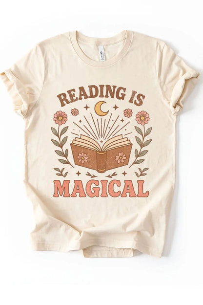 Soft cotton natural beige vintage t-shirt featuring an open book with flowers, a crescent moon, and the phrase “Reading Is Magical” in warm earthy tones.